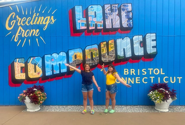 Photo of kids posing in front of Like Compounce sign