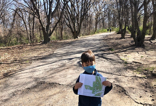 Boy on a park trial with map