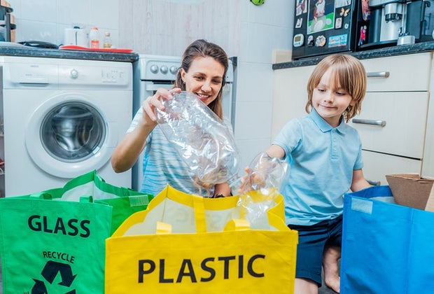 Almost all plastic bottles and food containers are recyclable. Make a game of sorting your recycling! (Mother and son recycling)