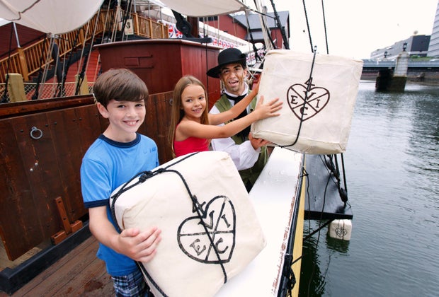 Image of kids throwing tea into Boston Harbor- 100 Things to do in Boston