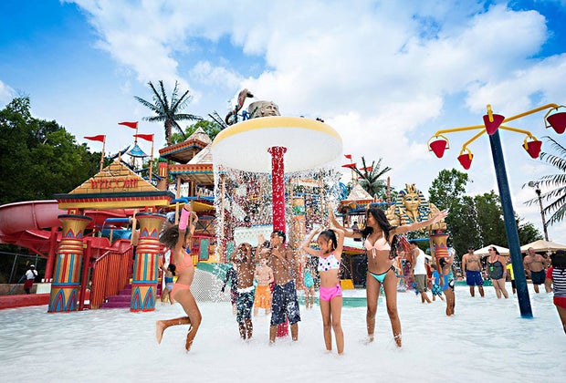 kids running through sprinklers at camelbeach
