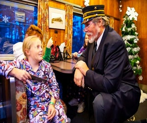Kids love to don pajamas and hand Christmas train conductors their golden tickets. Photo courtesy of the Cape Cod Central Railroad, Facebook