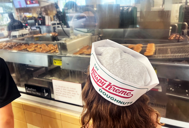 Krispy Kreme Doughnuts girl watching fresh doughnuts being made