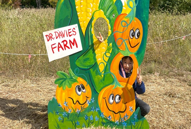 Hudson Valley fall family getaway: Boy posing with a sign at Dr. Davies Farm