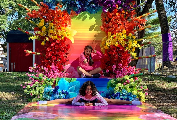 The blooms of The Fall Escape frame two girls striking a pose.