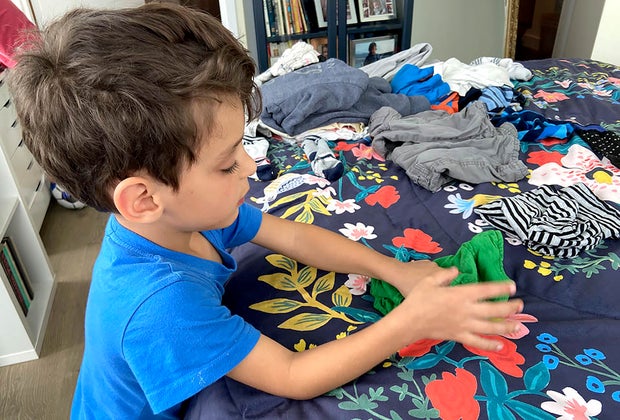 Sensory Activities for Toddlers, Infants, and Kids: Folding launrdy is a great sensory activity that gets your chores done!
