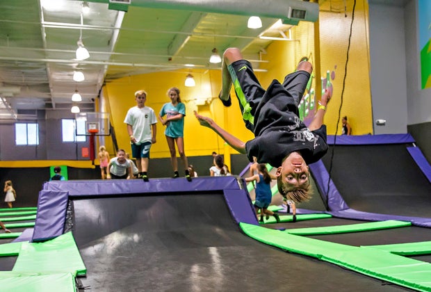 Boy doing a flip mid-air at Get Air Trampoline Park