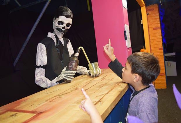 Haunt O'Ween "ordering" a drink from a skeleton