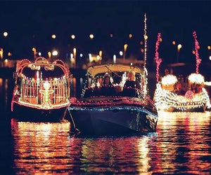 More than a dozen boats make their way down Freeport Village's iconic Nautical Mile at the Holiday Boat Parade. Photo courtesy of the event 
