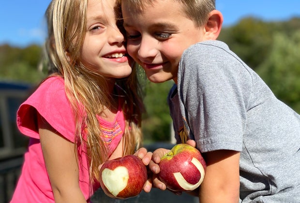 Photo of children holding apples at a CT apple orchard.