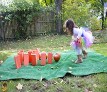 Even young kids can try pumpkin bowling. (They just need little pumpkins!)
