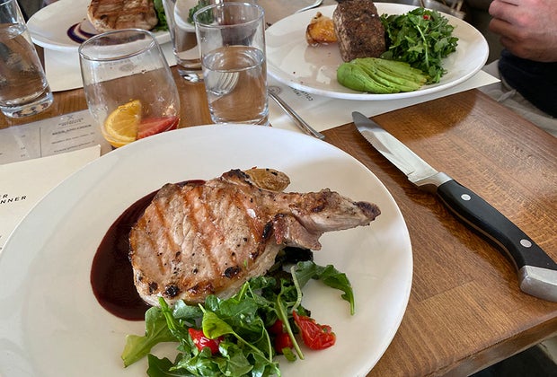 Pork chop on a plate at Three Peaks Lodge at Collective Governors Island