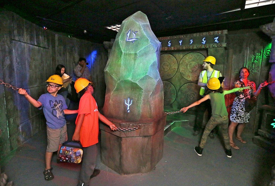 Kids work together to solve the puzzle. 