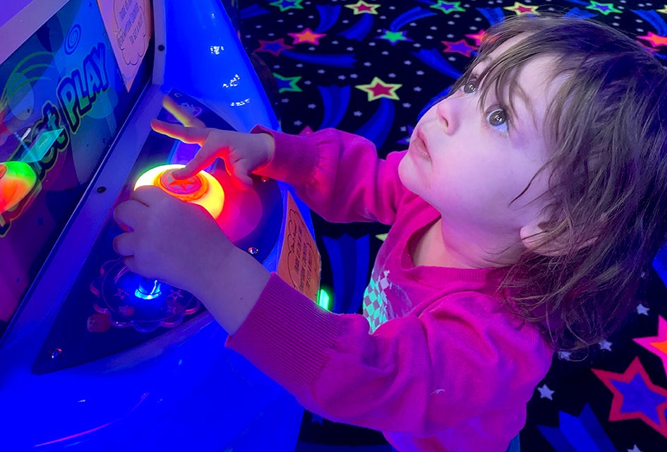 Toddlers love the bright lights of the arcade at Planet Play in Bellmore. Photo by Gina Massaro