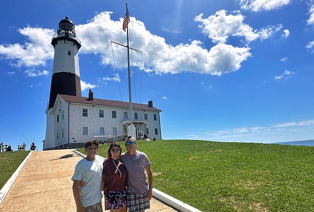 100 things to do on Long Island: Family in front of the Montauk Light House
