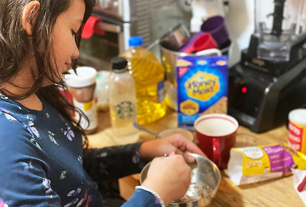 Girl mixes together a mug cake