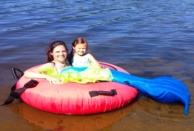 Image of mother and daughter floating in water at a Connecticut beach club.