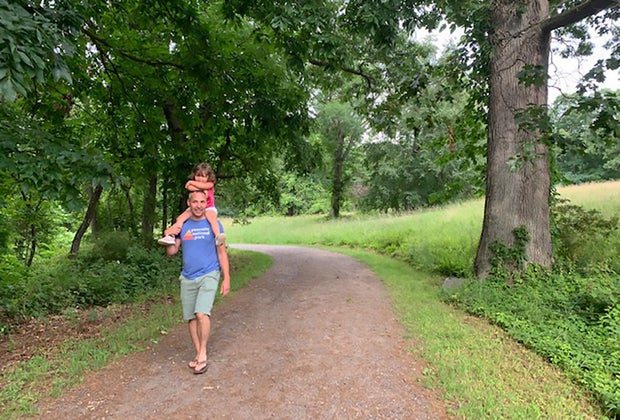 Father carrying daughter on shoulders in rockefeller state park