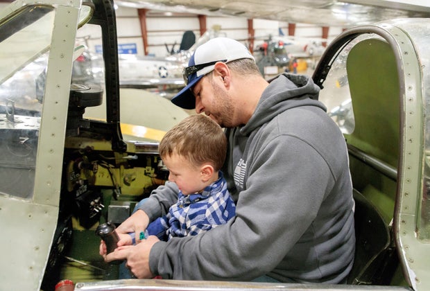 Image of father and son in a plane cockpit - Fall Bucket List for Kids