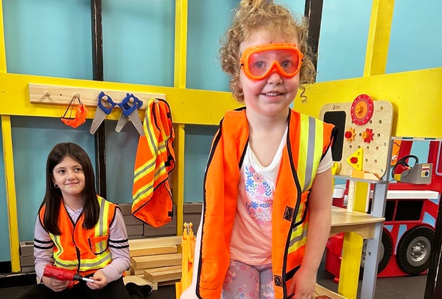 Trendy New Jersey Experiences for Kids: Adventure Nook girl in playing pretend construction gear