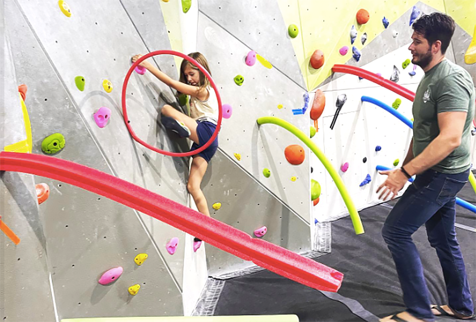 The climbing wall at DynoClimb challenges kids to climb to new heights.