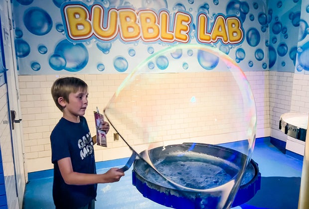 boy playing in Bubble Lab making giant bubbles