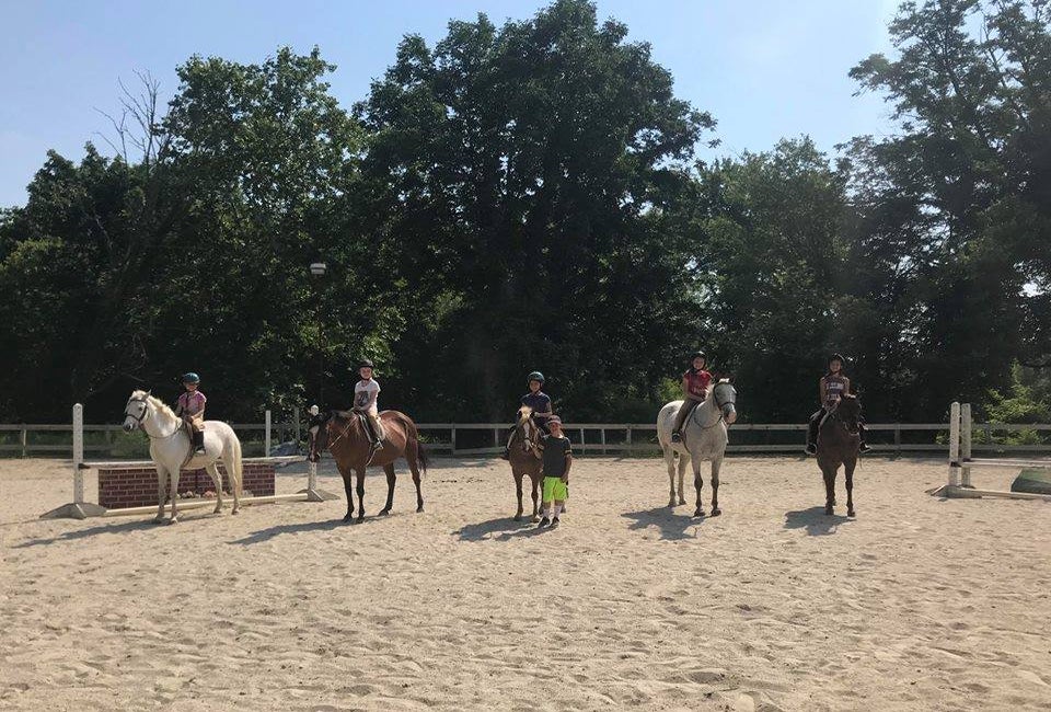 Campers get hands on riding experience at horseback riding camp. Photo from Out of Reach Farm