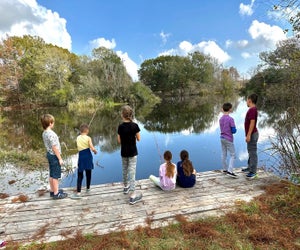 Kids fishing in a lake at EcoCamp. Photo courtesy of the Armand Bayou Nature Center 
