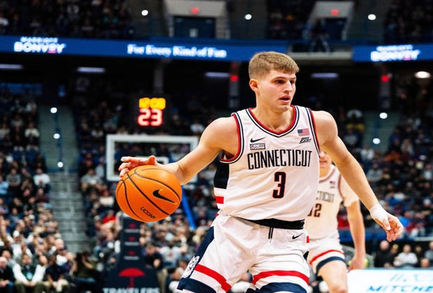 Photo of UConn college basketball player with a basketball.