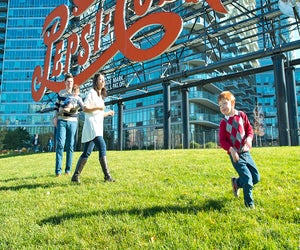 Play under the  iconic Pepsi Cola sign. Photo by Sidney Ng