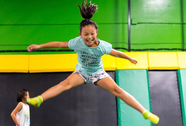 Girl doing a mid-air split at Rockin' Jump Trampoline Park