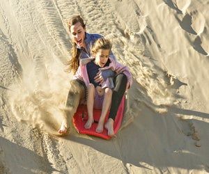 Grab a board and try sand sledding.