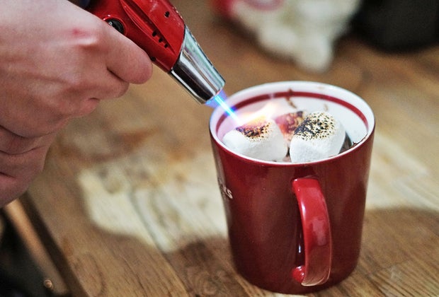 Kitchen torch toasts marshmallows atop at mug cake