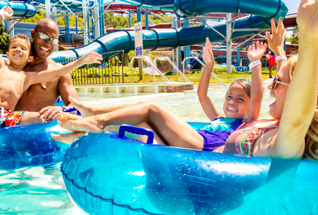 family on inflatable tubes at Calverton's Splish Splash Water Park: Summer Bucket List of Things To Do on Long Island