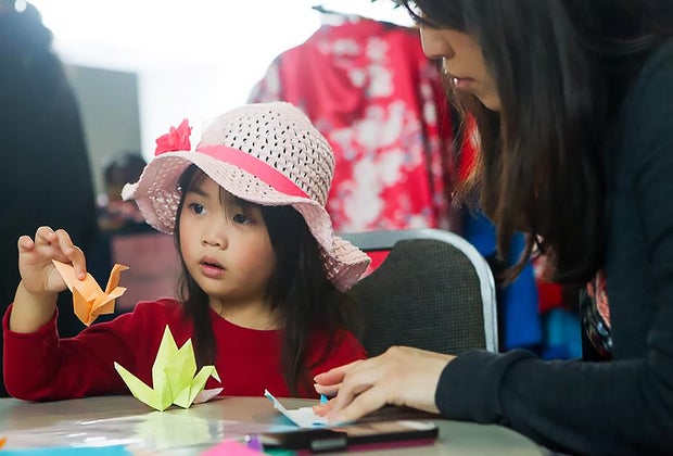 child learning origami