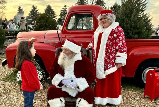 Mr. and Mrs. Claus have a great photo-op with a little red truck at Santa's Christmas Tree Farm in Cutchogue. Photo by Jennifer Voit