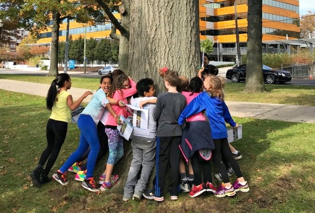 Kids bond with trees—and one another—at the Mill River Park Scavenger Hunt. Photo courtesy of Mill River Park Collaborative