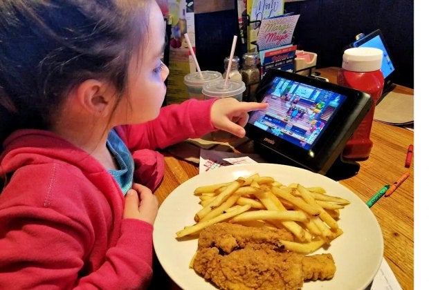 Keep the kids busy at Applebee's with games on a tableside tablet. Photo by Anne Caminiti - Momee Friends of Long Island  www.momeefriendsli.com 