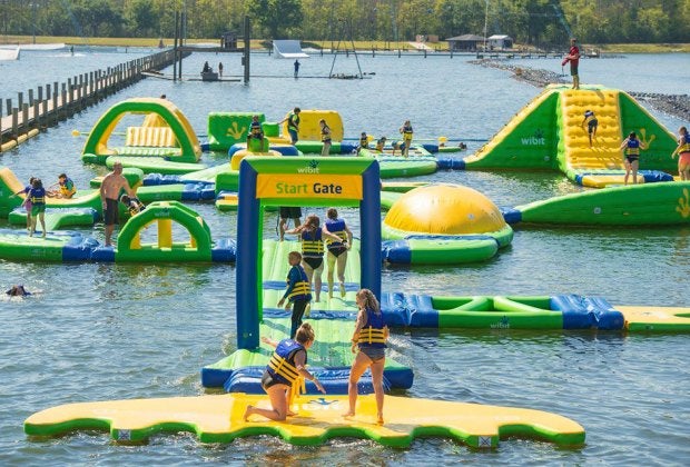 Hit the obstacle course at these inflatable Orlando water parks. Photo courtesy of The Orlando Watersports Complex