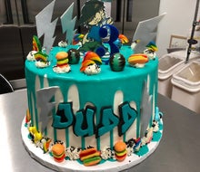 At Armonk's Sugar Hi, specialty cakes include a brightly-colored ganache drip with candy pieces. Photo courtesy of Sugar Hi