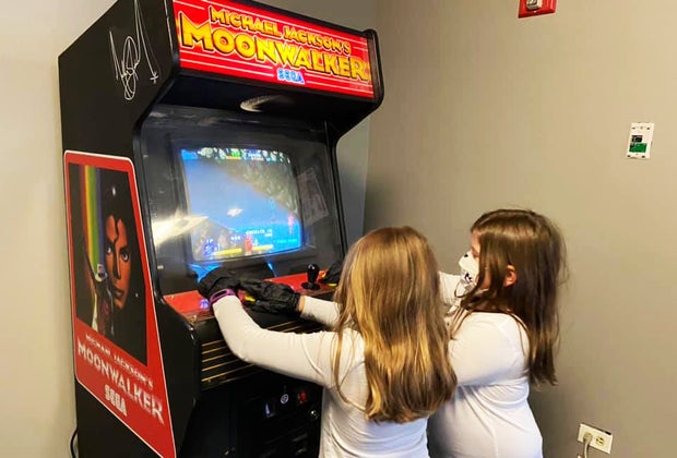 Girls play arcade games at the Cradle of Aviation Museum What's open Now Long Island