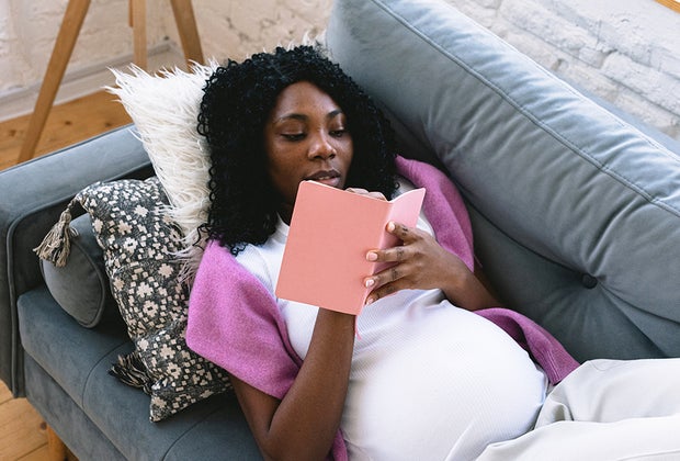 Pregnant woman resting on couch