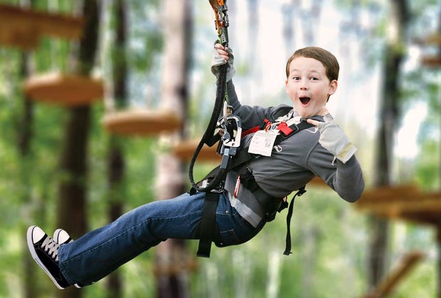 Photo of a child on a zip line, a popular Father's day activity.