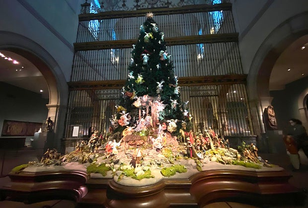 The Met with Kids: The magnificently lit, twenty-foot blue spruce looms over a vivid eighteenth-century Neapolitan Nativity scene,